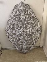 Single plaque leaning against wall showing full design