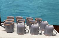All twelve Noritake Blue Adobe mugs upright and inverted