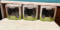 Front view of three sealed Psyclone Essentials wireless Xbox controllers