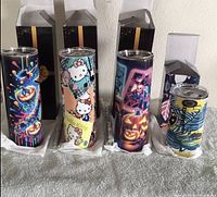 Front view of all five tumblers with boxes behind first four