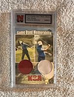Front of encased card showing Tiger Woods image, shirt and glove swatches