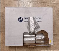 cardboard case labeled Inteplast Group with rolls of silver trash bags visible