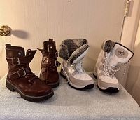 Brown leather boots and white snow boots side by side