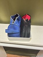 Two zippered makeup bags in tray