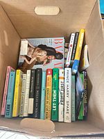 Box with row of self-help and nonfiction book spines, titles and condition visible