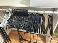 Rack of assorted black velvet, plastic and metal hangers