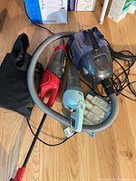 All vacuums, hose, wand, cleaning kit visible on floor
