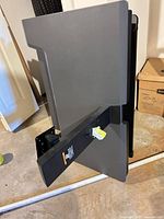 Side view of folded workstation showing monitor arm and wall mount bracket