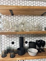 overview of mixed glass and plastic items on wooden shelves
