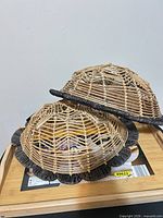 Two rattan dome baskets on bamboo tray