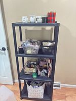 Full shelving unit showing variety of wax melts, candles, warmers and baskets