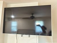 Front view of TCL 65-inch TV mounted on wall