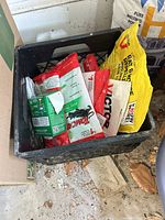 Crate containing various sealed Tomcat and Victor rodent control packages