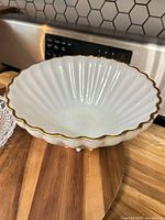White porcelain footed serving bowl with scalloped gold-trim rim