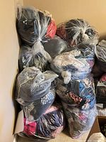 Stack of sealed clear bags filled with folded clothing