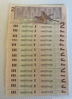 Stack of 14 sequential 1986 Canadian $2 bills showing serial numbers CBD3779241-CBD3779254