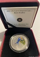 Coin in capsule inside presentation case with certificate card visible