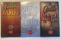 Front view of three sealed presentation cards for 2000, 2001, 2002 colourized 25-cent coins