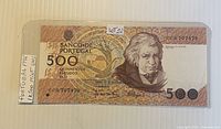 Banknote in protective sleeve showing full obverse with serial and denomination
