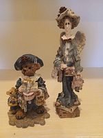 Both figurines standing side by side to show overall appearance and comparative size