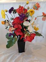 Full view of silk flower arrangement in black ceramic vase