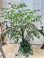 Full view artificial tree with planter in room setting