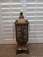 Front view of urn-shaped decorative vase with lid, finial, and prisms