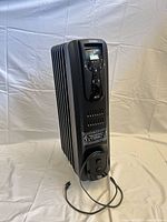 Full view of DeLonghi radiator heater showing fins and overall condition