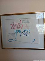 Full view of framed print with gold-tone frame on wall