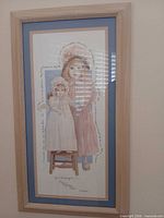 Full view of framed D. Morgan print showing girl with doll, frame and mats