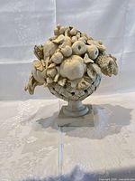 Full view of assembled centerpiece showing bouquet top on urn base