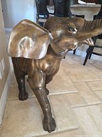 Left front view of full elephant showing bronze finish and size