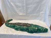 full view of crocodile sculpture on tablecloth