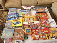 Full layout of all board games on white surface showing variety of titles