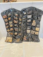 Front view of both filled pocket organizers showing jewelry quantity and variety