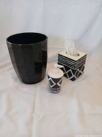 wastebasket, soap dispenser, tissue box cover grouped on white backdrop
