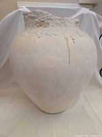 Front view of off-white distressed ceramic vase
