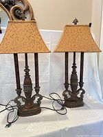 Front view of both matching bronze/gold table lamps with fabric shades