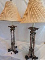Full view of both matching beige table lamps with shades