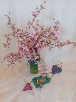 Overall lot: vase with flowers and wall mirror on surface