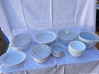Group view of all ceramic pieces and lids on table