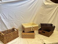Group shot of four rectangular wicker and rattan baskets