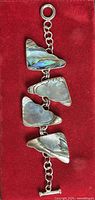 Front view of bracelet showing abalone shell panels and toggle clasp