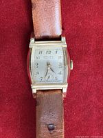Front view showing dial, case, and strap
