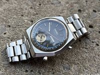 Angled view of watch face, case, pushers and bracelet