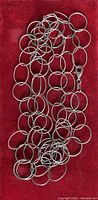 Full view of necklace laid flat showing circular link pattern