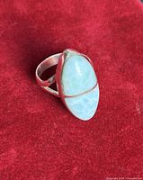 Front oblique view of sterling ring showing blue cabochon and split bezel