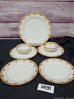 Group shot showing platter, plates and compote bowls with pattern and scale tag