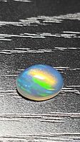 Top view of oval Ethiopian crystal jelly opal showing multicolor play-of-color