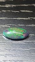 Top view of marquise Ethiopian black opal showing play-of-color